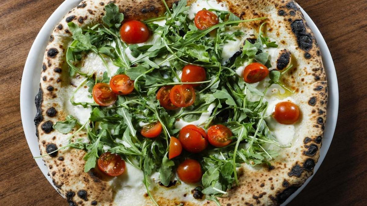 Among the pizza offerings at Flour House in San Luis Obispo is the pizza bianca-style Primavera, topped with mozzarella di bufala, tomatoes and arugula.