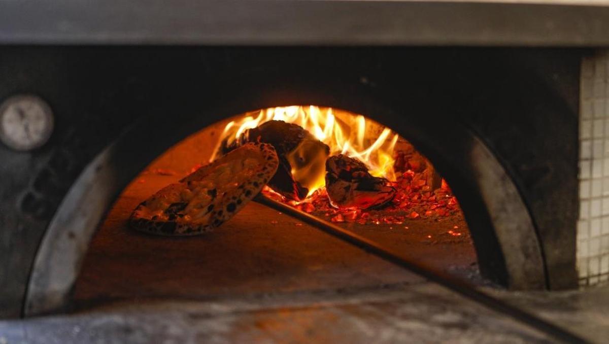 Pizza is baked at 1,000 degrees Fahrenheit in a wood-fired oven at Flour House in San Luis Obispo.