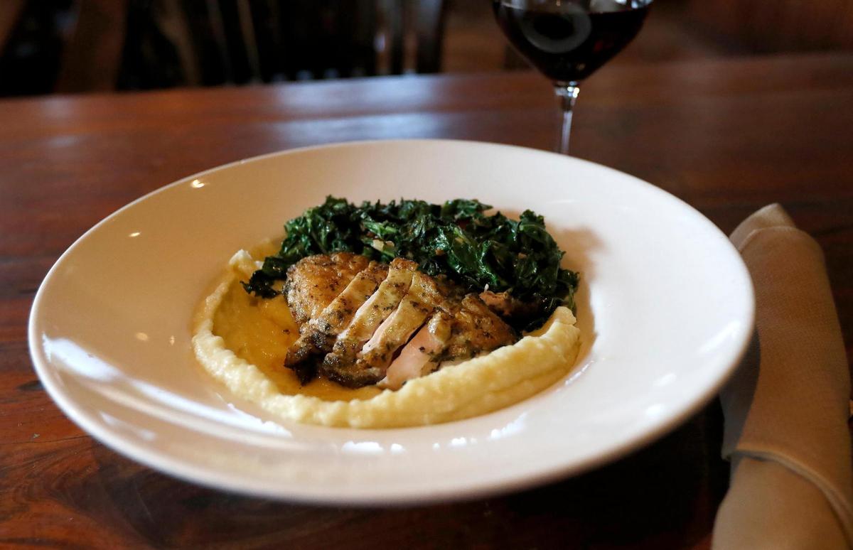 Skin on grilled chicken breast marinated in pesto, served with sautéed kale, cherry tomatoes and mashed potatoes.