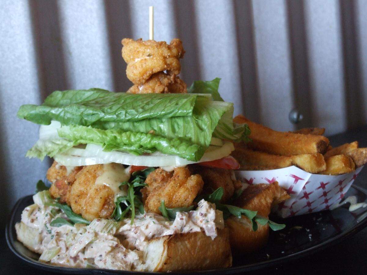 The white prawn po’ boy sandwich at Flavor Factory in Morro Bay comes with lump crab salad, tomato, onion, lettuce and Creole mayo on a toasted lobster roll.