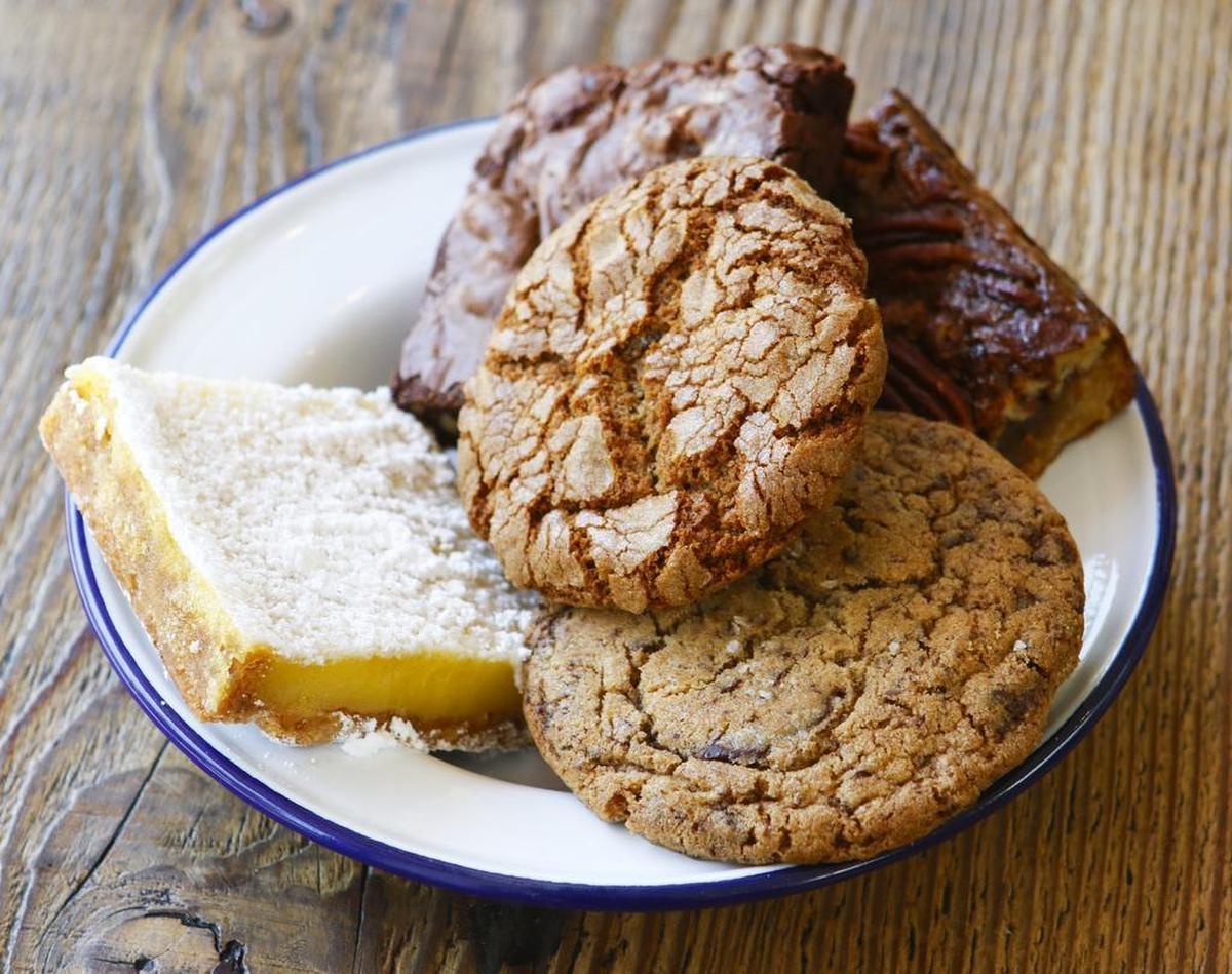Desserts at SLO Provisions in San Luis Obispo include, clockwise from left, a lemon bar, walnut brownie, Southern pecan bar, salted chocolate chip cookie and gingersnap cookie.
