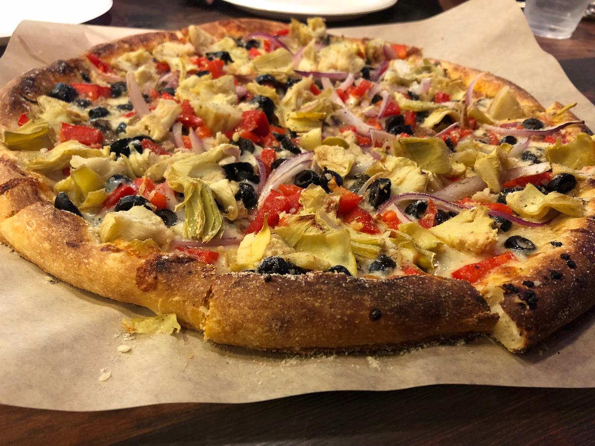 At Rustic Fire in Paso Robles, the roasted veggie pizza comes loaded with mozzarella cheese, artichoke hearts, bell peppers, tomatoes, red onion, black olives and a generous dusting of Parmesean cheese
