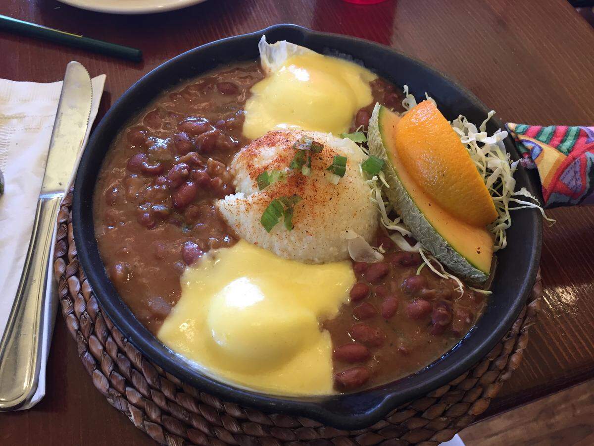 The Cajun Breakfast features red beans, poached eggs and Hollandaise sauce, served with grits and a buttermilk biscuit, at Bon Temps Creole Cafe in San Luis Obispo.