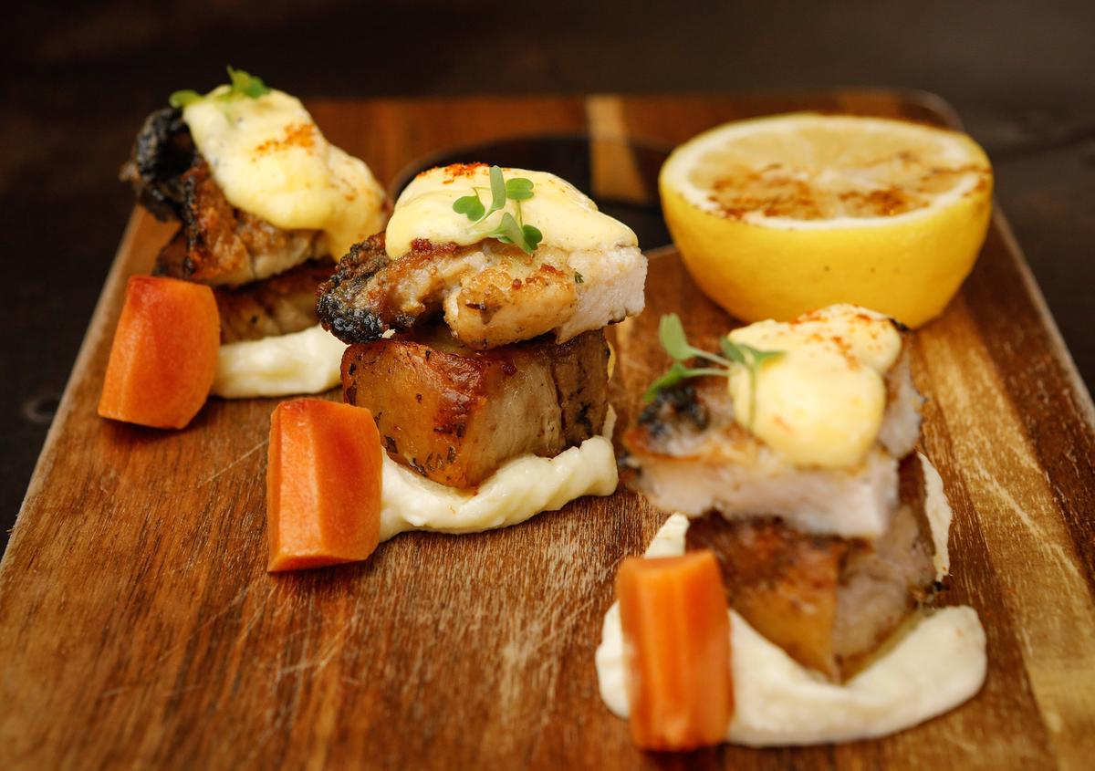 Abalone/Pork Belly with Cayucos ocean rose abalone steak, braised pork belly, spicy sabayon sauce, parsnip mousse, and poached persimmons from La Bodega Tapas, a new Pismo Beach restaurant specializing in Spanish-style tapas. Photo by Joe Johnston 02-01-19