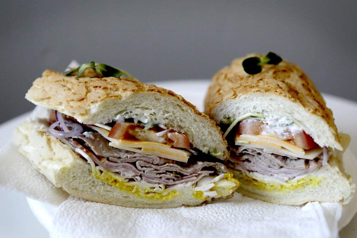 The Closeout at Surfside Deli in Grover Beach features roast beef, ham, turkey and cheddar topped with swiss cheese, tomato, onion, sprouts, mayo and mustard stuffed in a Dutch crunch roll.