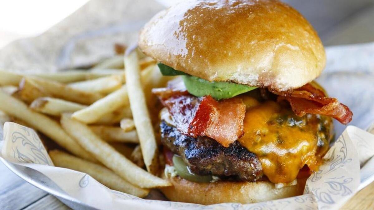 The California Classic burger at Figueroa Mountain Brewing Co. in Arroyo Grande comes with avocado, bacon, cheddar cheese and a Hoppy Poppy IPA sauce.