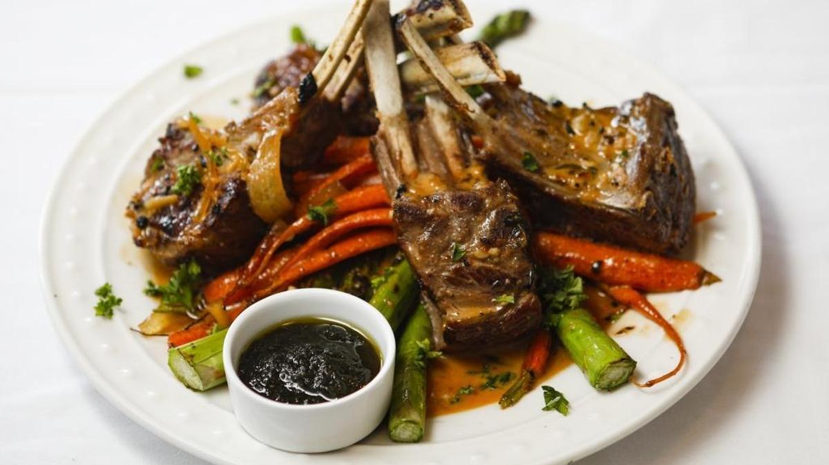 New Zealand rack of lamb is served with caramelized onion marmalade, asparagus and baby organic carrots at The Burton House and Grill in Nipomo.