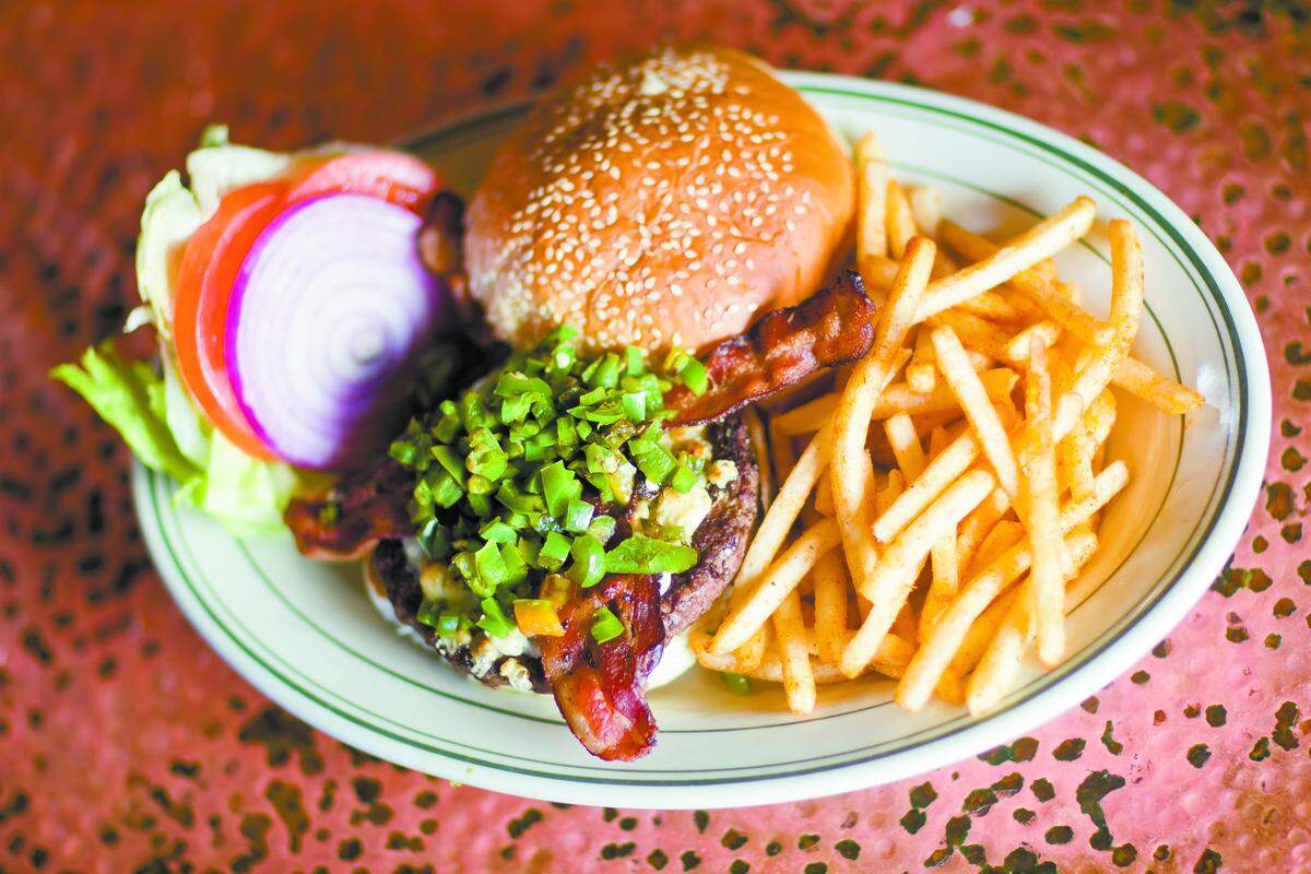 The Jalapeño Black and Blue Burger is a Guinness Burger topped with grilled fresh jalapeños, crumbled blue cheese and applewood smoked bacon.