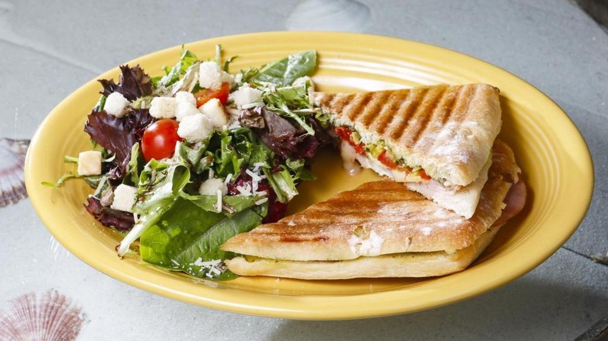 The Toscana panini at The Gourmet Deli at Old Edna features thin-sliced lean ham with aged sharp provolone cheese, roma tomatoes, pepperoncini and freshly made pesto using locally grown basil.