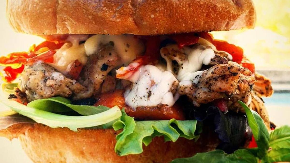 Slow-smoked, pulled chicken is the star in a Caprese sandwich served by The Hurricane Kitchen food truck.