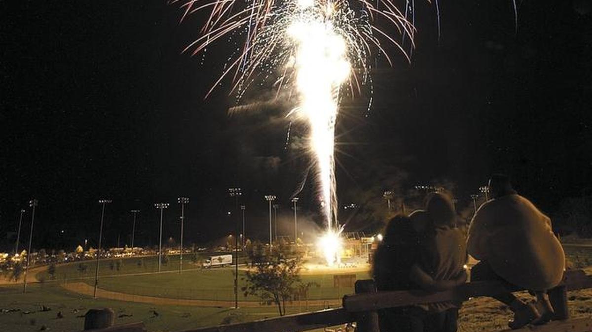 Spectators at Barney Schwartz park in Paso Robles watch fireworks at July 4 festivities in 2004.