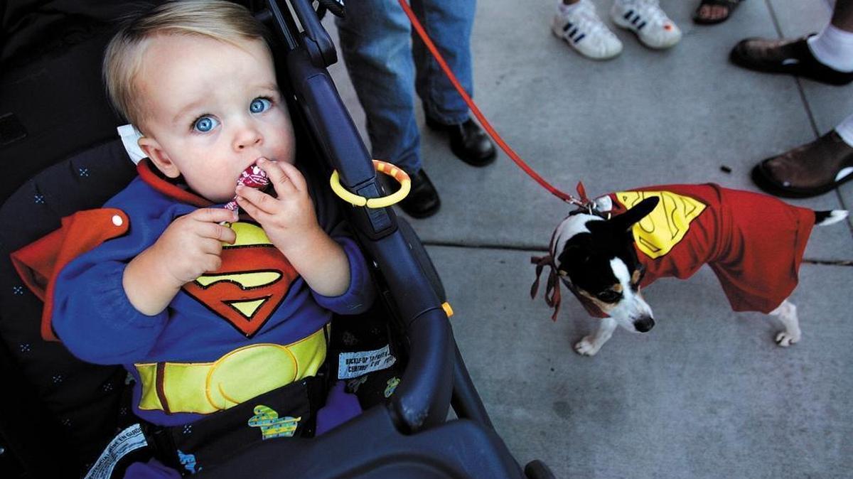 Joe Larwood, 4, of Atascadero and his buddy Quincey go trick-or-treating in downtown Paso Robles.