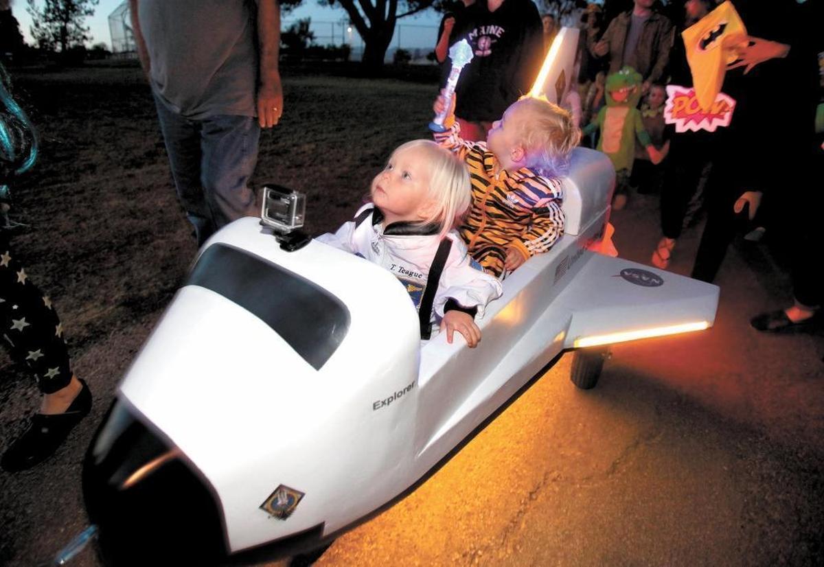 Tori Teague, 2, and Gus Dubois, 2.5, both of San Luis Obispo, ride in a miniature space shuttle during a Halloween parade at Meadow Park in San Luis Obispo. The park hosts the Boo Bash! on Oct. 27.