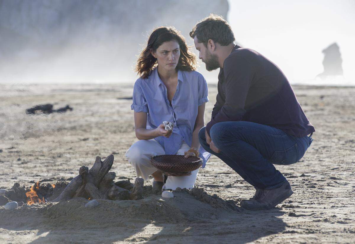 Delphine (Phoebe Tonkin) and Cole (Joshua Jackson) share a moment on the beach in front of Morro Rock in a scene from Showtime's "The Affair." Shot in Morro Bay in January 2018, the episode airs July 15, 2018, on Showtime.