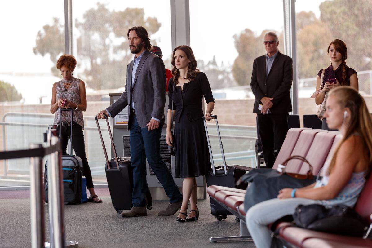 Frank (Keanu Reeves), second from left, and Lindsay (Winona Ryder), third from left, wait in line in a scene from “Destination Wedding,” filmed at the San Luis Obispo County Regional Airport.