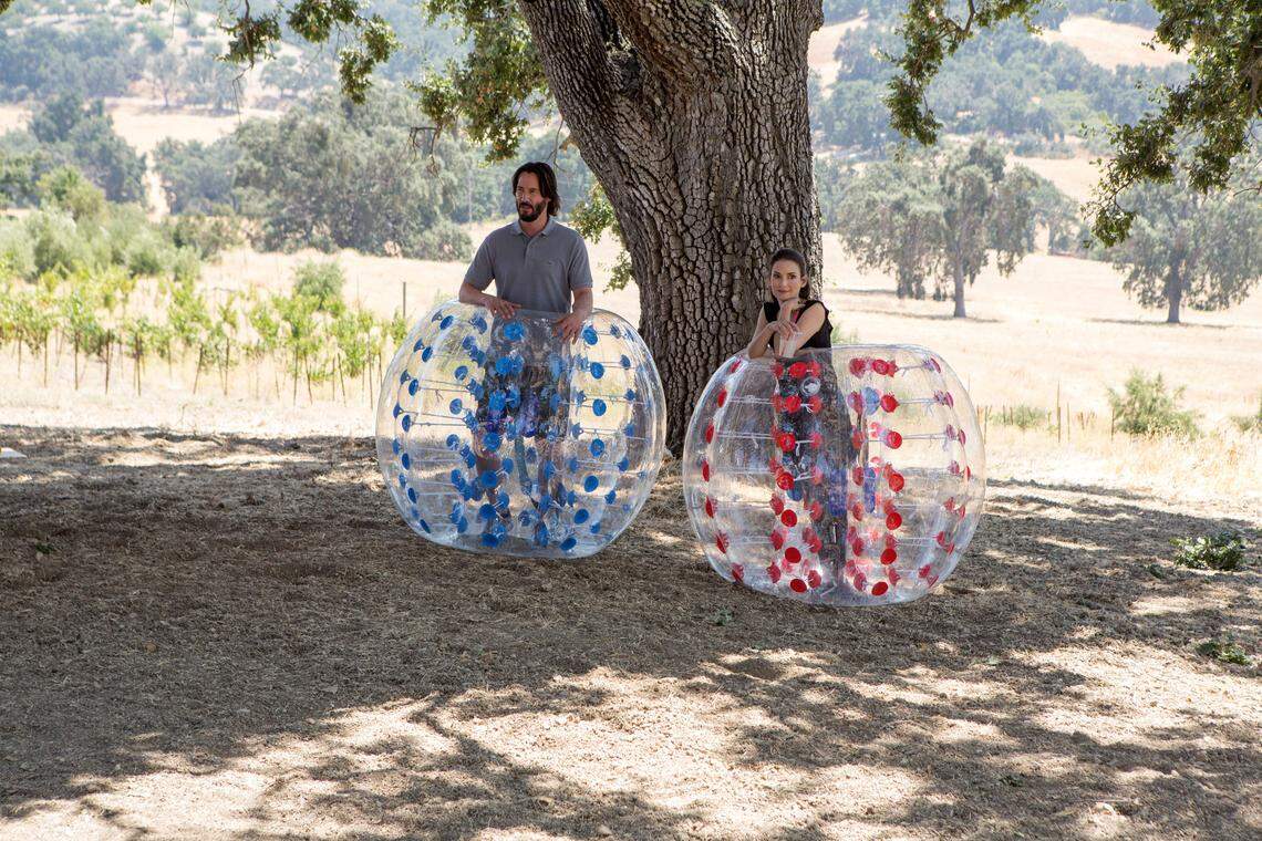 Frank (Keanu Reeves) and Lindsay (Winona Ryder) take a break in a scene from “Destination Wedding,” filmed at Dubost Vineyard & Winery in Paso Robles.