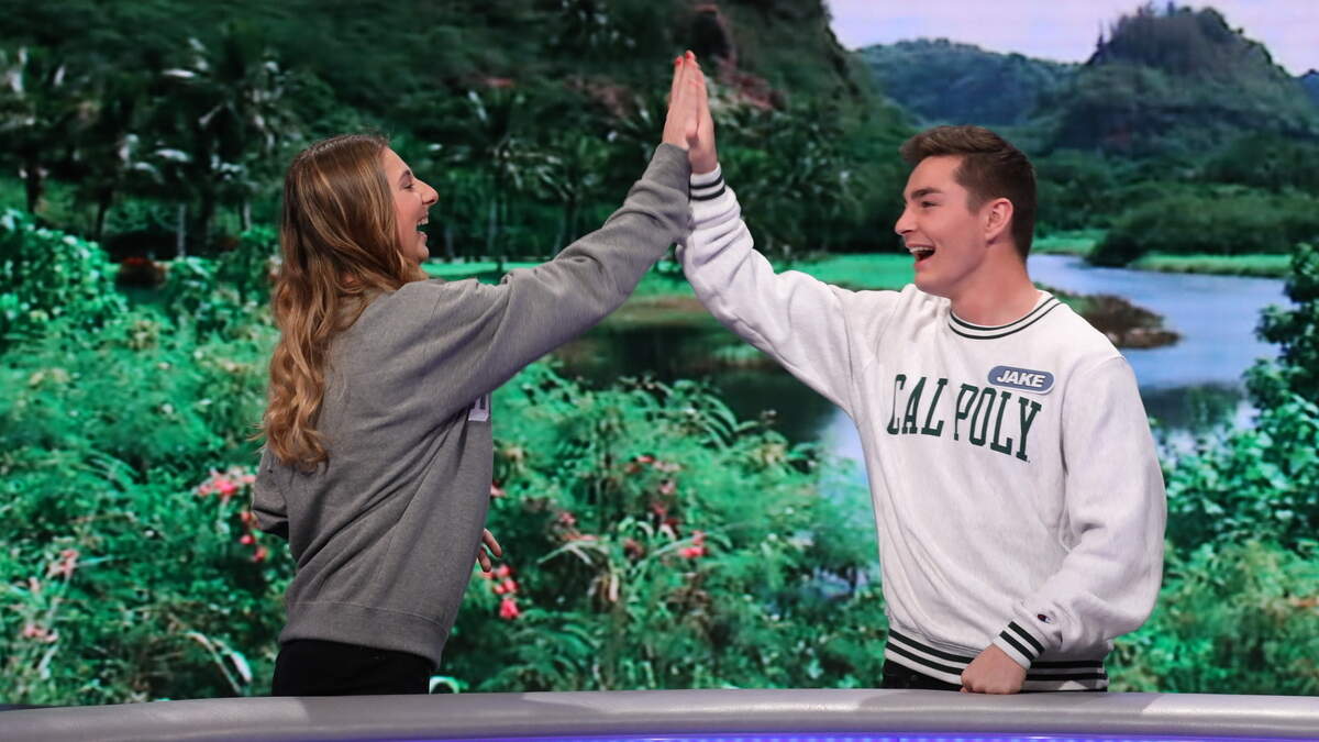 Cal Poly student Jake Douglas, right, high-fives another contestant, University of Dayton student Mary Schultz, on TV’s “Wheel of Fortune.” The two appear on the popular game show on Monday, March 18, 2019.