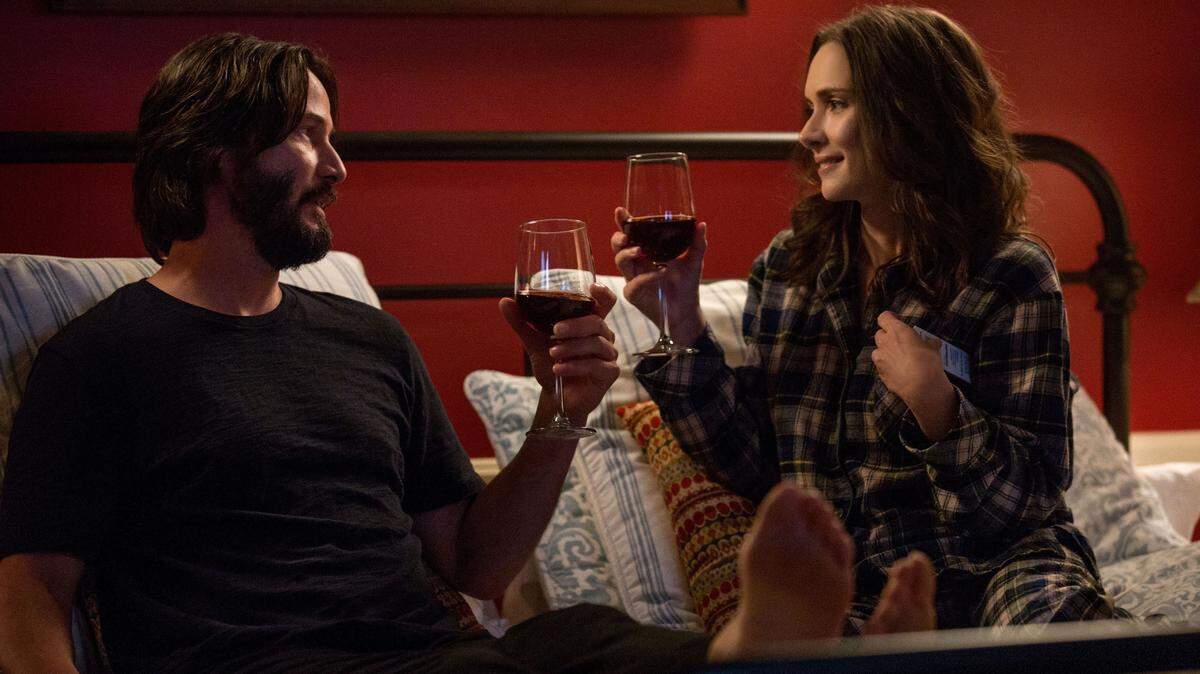 Frank (Keanu Reeves) and Lindsay (Winona Ryder) share a drink in a scene from “Destination Wedding,” filmed at the Apple Farm Inn and Restaurant in San Luis Obispo.