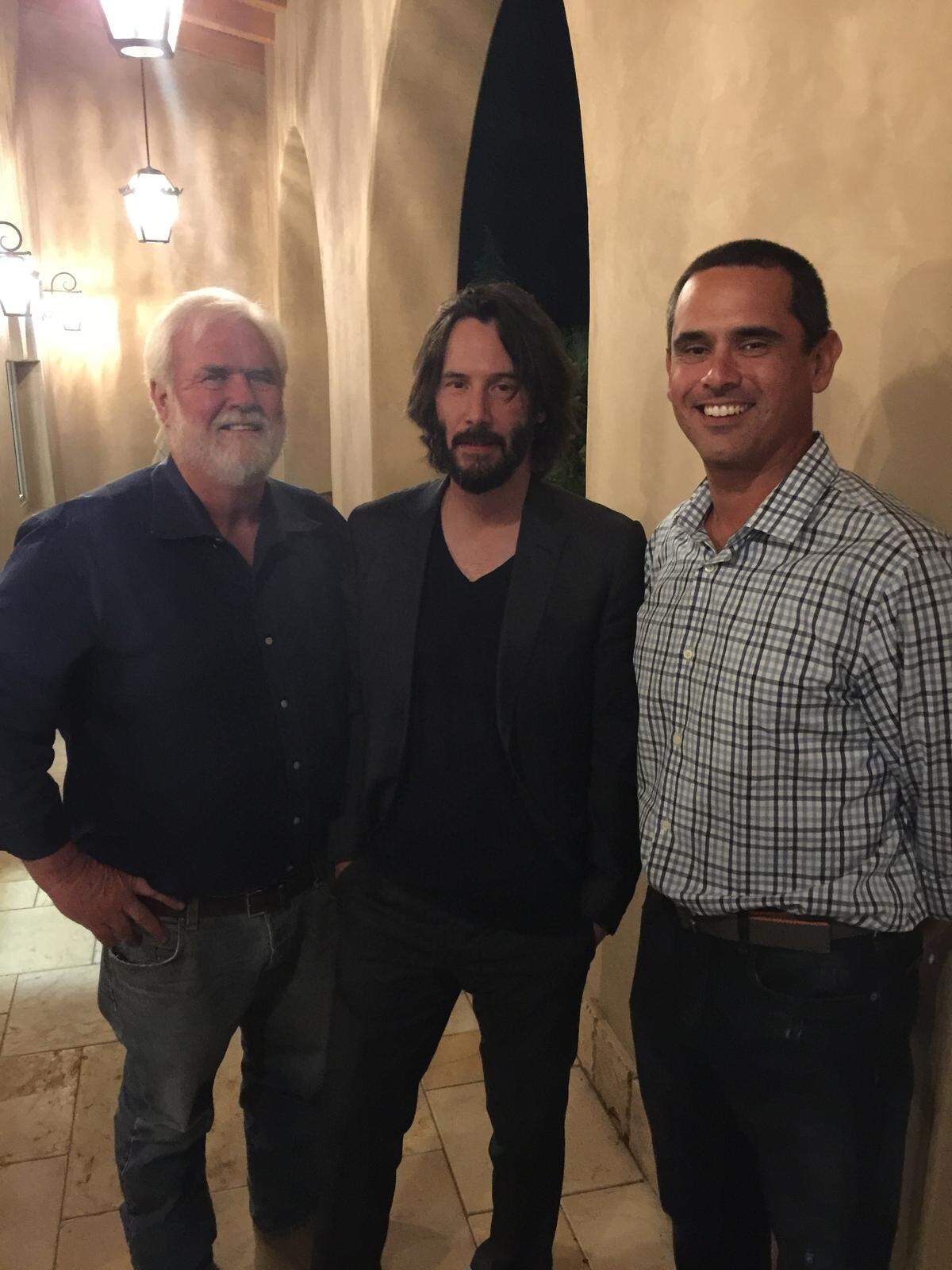 Curt Dubost, left, and his son Ted Dubost, right, pose for a picture with Keanu Reeves at Dubost Vineyard & Winery in Paso Robles. "The Matrix" star shot part of his movie "Destination Wedding," at the winery in August 2017.