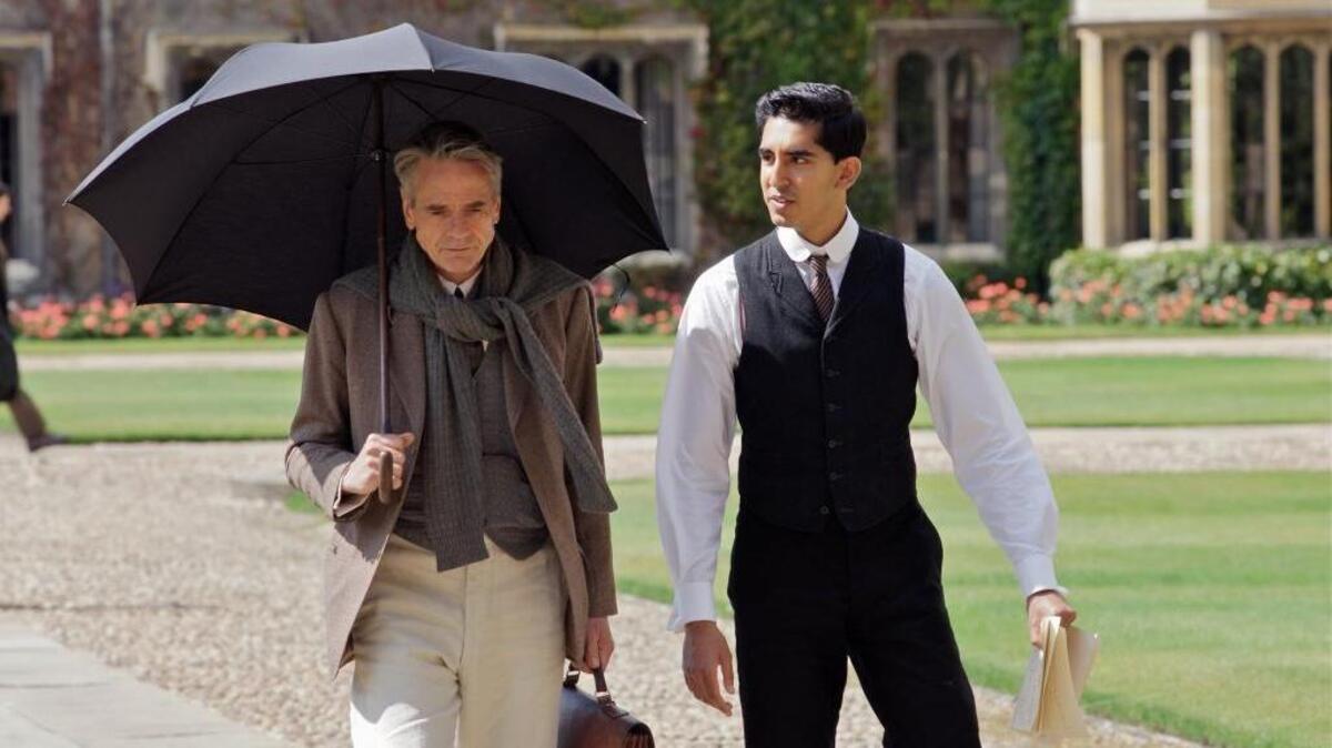G.H. Hardy (Jeremy Irons) and Srinivasa Ramanujan (Dev Patel) walk through the Quad at Trinity College, Cambridge, in “The Man Who Knew Infinity.”
