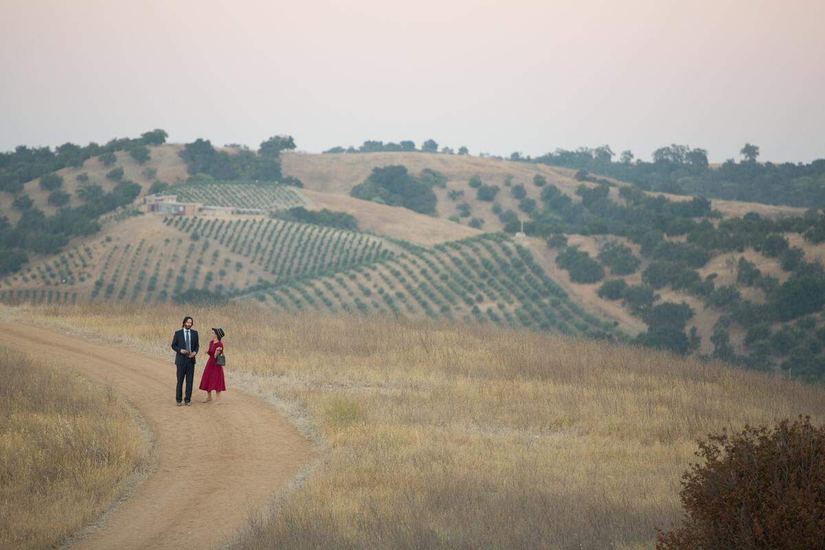 Frank (Keanu Reeves) and Lindsay (Winona Ryder) take a walk in a scene from “Destination Wedding,” filmed at Dubost Vineyard & Winery in Paso Robles.