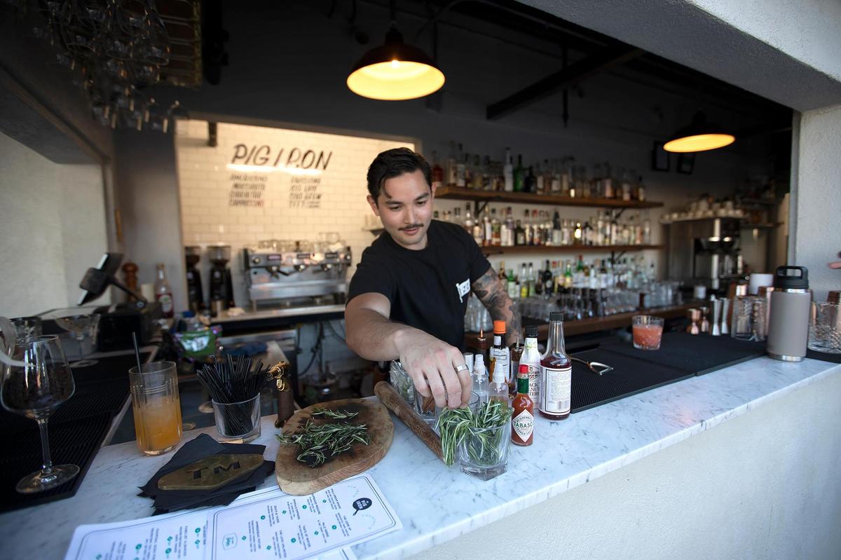 The Pig Iron has an outdoor heated patio and fire pit at the former A.J. Spurs on Main Street in Templeton, CA. Bartender Josh ‘J.P.’ Perez serves up delicious drinks for customers.