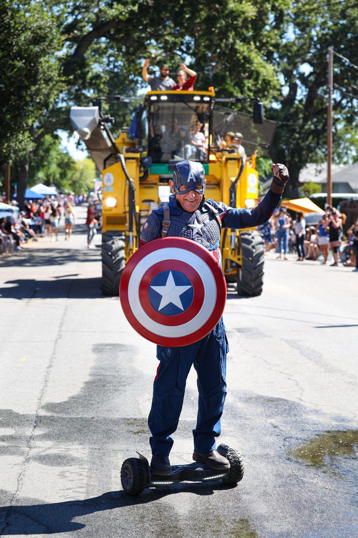 A good friend of Captain America, Richard Smith, hoverboards the parade route ahead of a grape harvester during the Templeton 4th of July Parade on Tuesday, July 4, 2023.