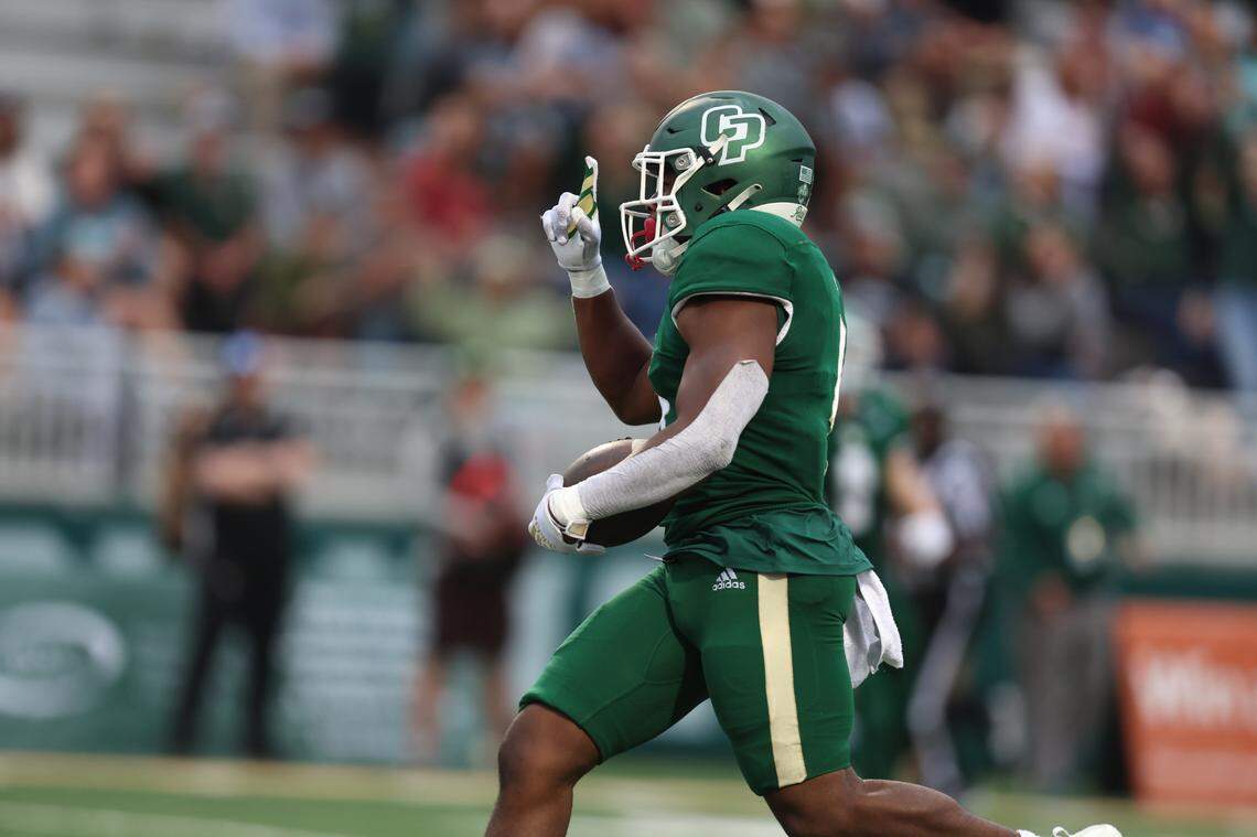 Cal Poly running back Mark Biggins (4) points to the sky after scoring a touchdown against the University of San Diego on Sept. 1, 2023, in the Mustangs’ home opener.