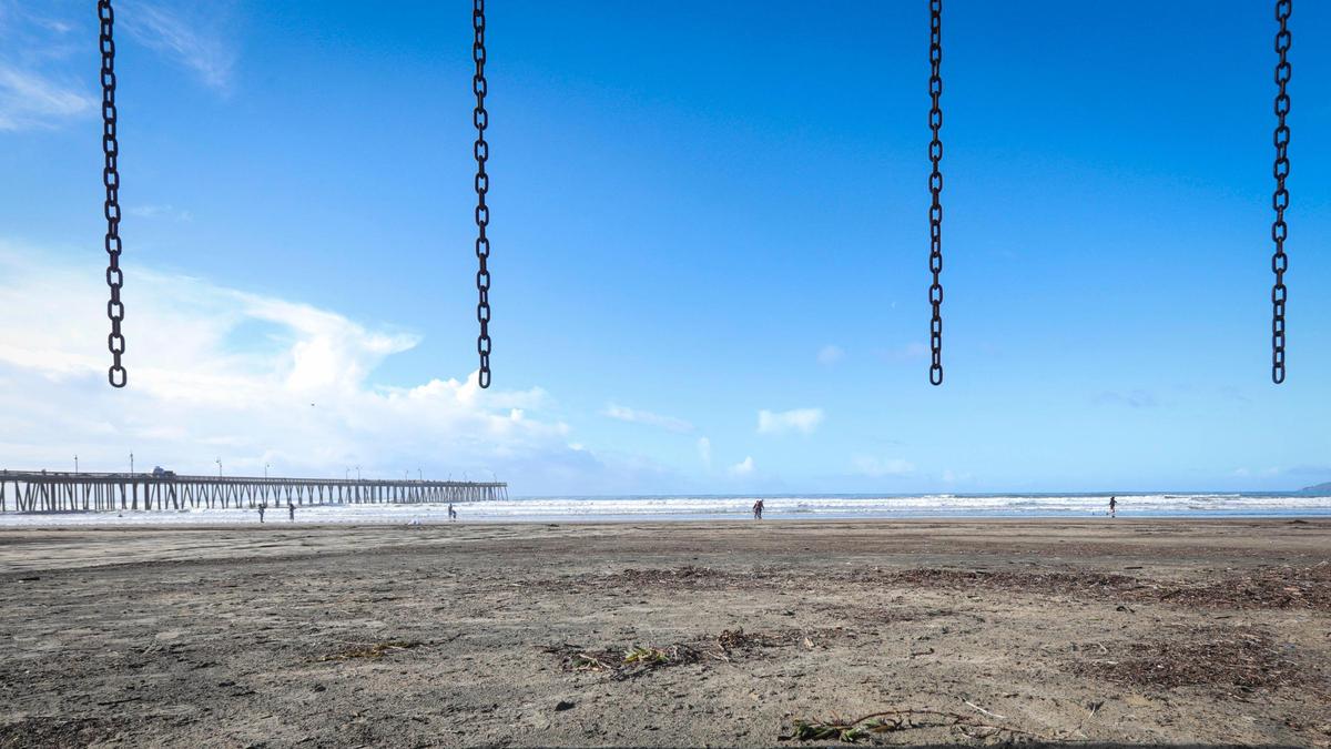 A swing set on Pismo Beach only has its chains left after heavy surf and high tides in the last week of 2023 damaged equipment, seen here Jan. 3, 2024.