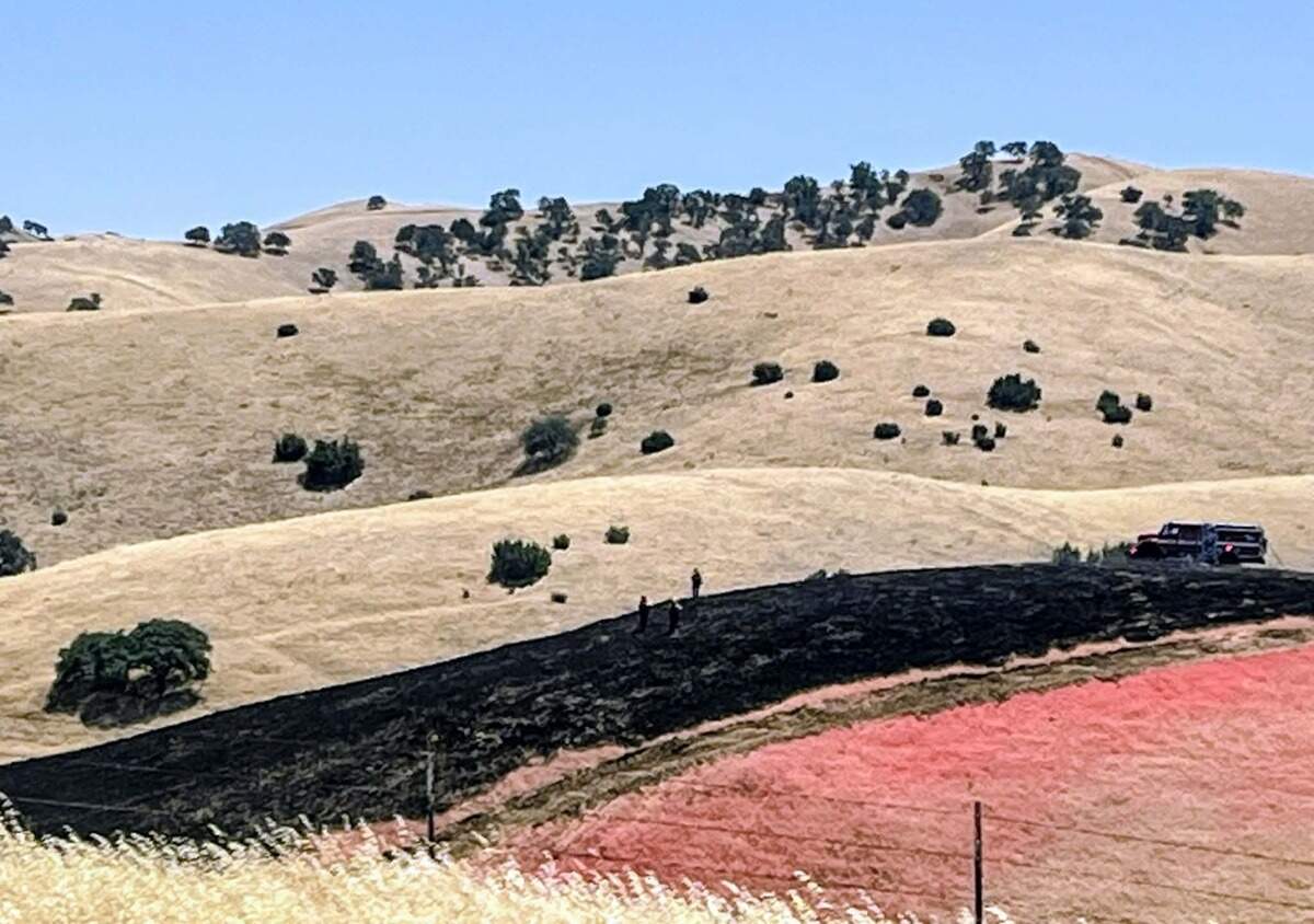 Firefighters worked along a burned hillside as crews responded to the Cotton Fire near the San Luis Obispo-Kern county line north of Highway 41 on June 7, 2026.