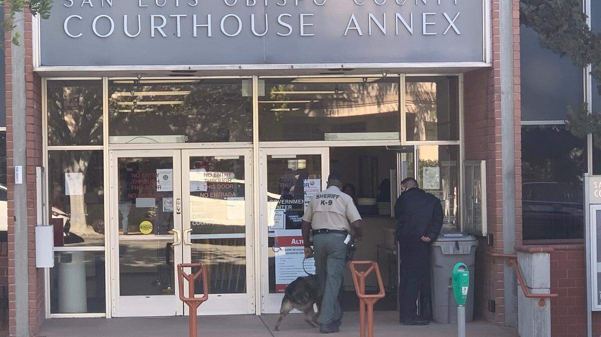 A San Luis Obispo Sheriff’s Office K-9 unit enters the San Luis Obispo County courthouse annex on Tuesday, March 2, 2021. The courthouse was evacuated due to a threat.