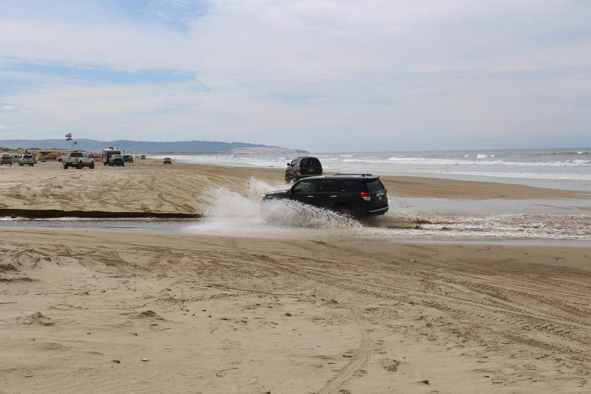 A car drives up Arroyo Grande Creek at Oceano Dunes State Vehicular Recreation Area on Sunday, March 14, 2021. If the California Coastal Commission adopts its staff’s recommendations, this activity would be prohibited to protect the animals that use the creek.
