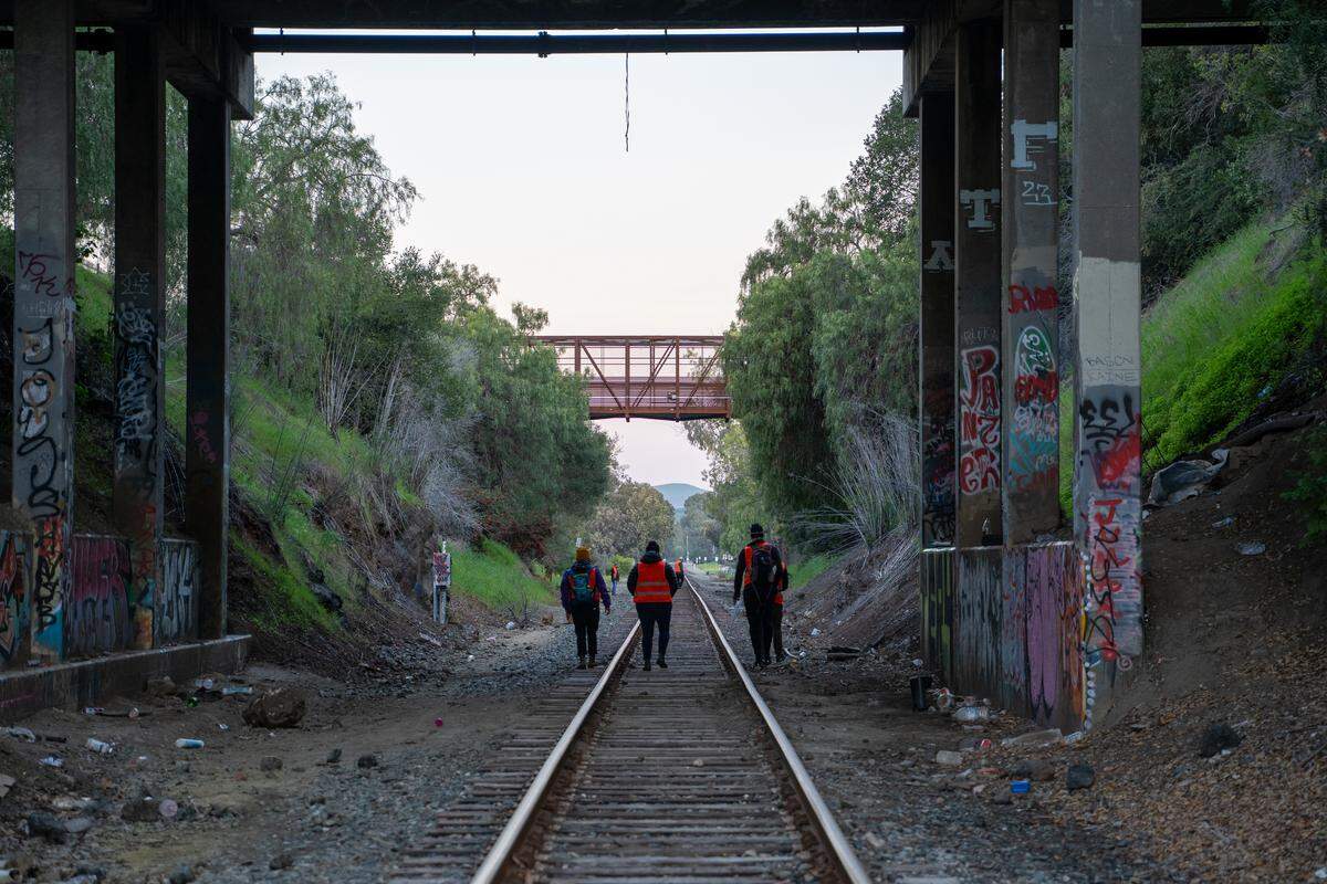 Point-In-Time Count volunteers walk along the railroad tracks near Monterey Street in San Luis Obispo on Tuesday, Jan. 27, 2026. The PIT Count is held every other year, and relies on networks of volunteers who count and survey as many homeless individuals as possible.