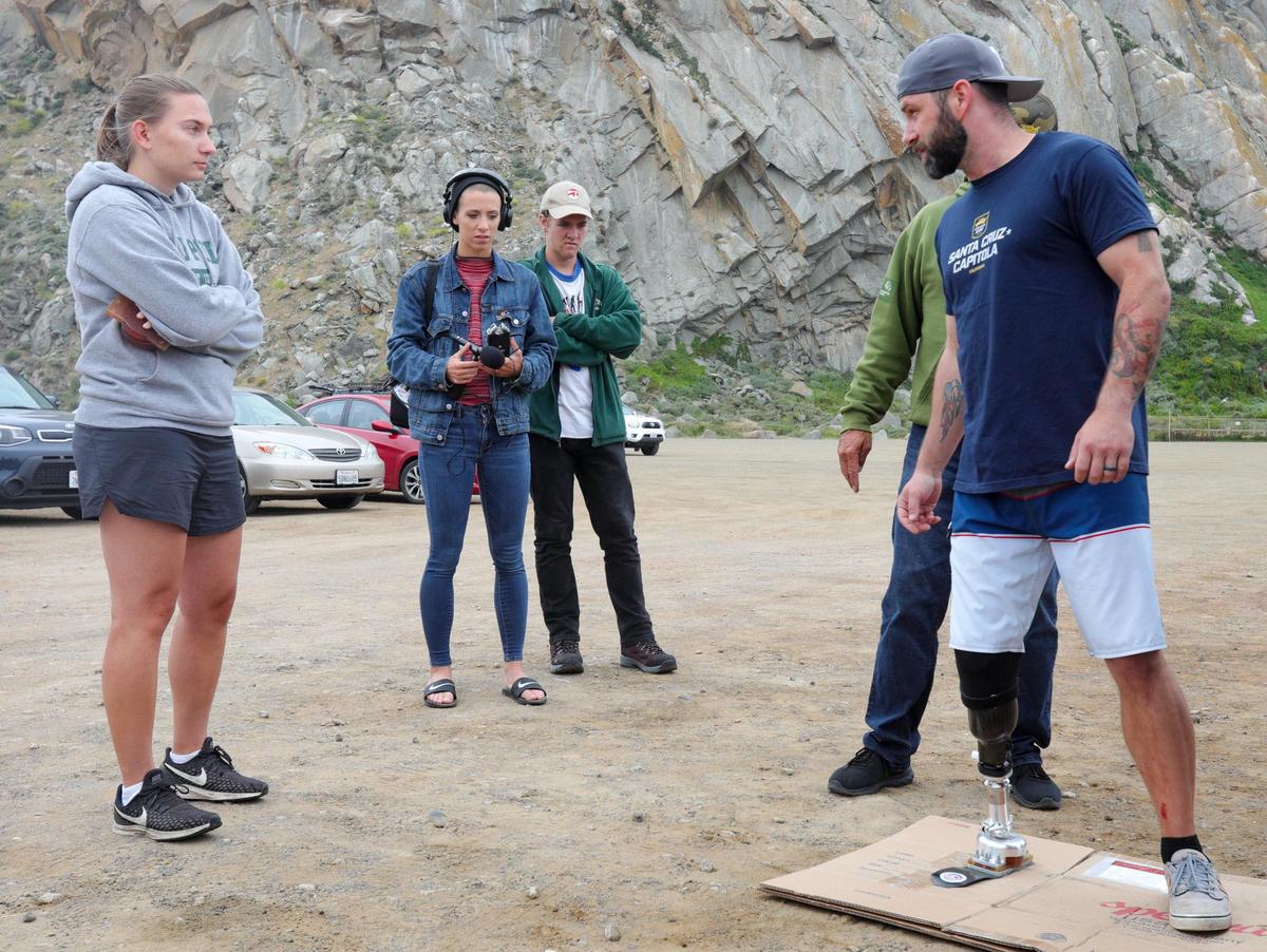 Cal Poly student Caroline Swanson, left, talks to Kyle Kelly, a veteran who lost his lower right leg to a roadside bomb in Iraq. Her senior project was a new prosthetic limb specifically for improved ankle movement while surfing.