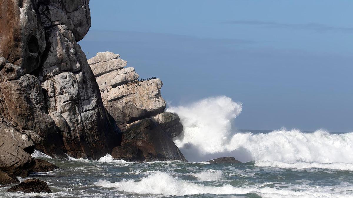 Large waves crash against the “Man in the bathtub” formation at Morro Rock on Monday, Feb. 19, 2024, after a storm slammed San Luis Obispo County on Sunday night, bringing with it rising creeks and rivers and at least one swift water rescue.