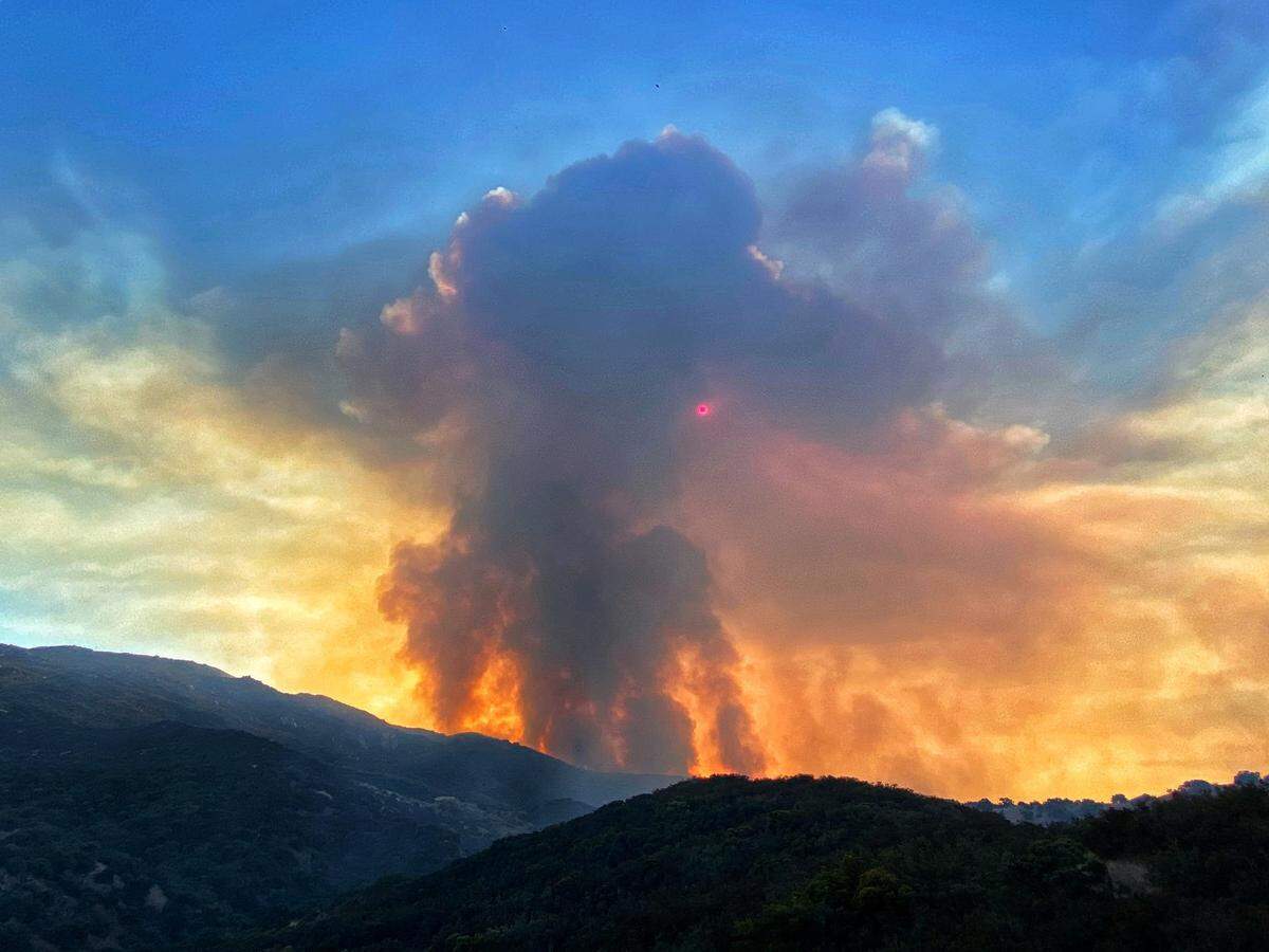 Fire activity blocks out the sun Tuesday morning as flames move north towards East Camino Cielo in the Los Padres National Forest.