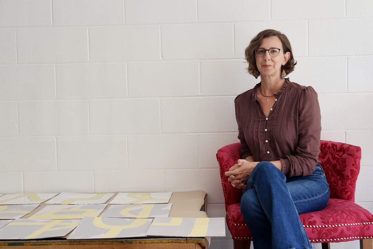 Artist Allie Mount, co-owner of Fieldwork in Atascadero, poses next to her latest project, interactive tile designs for the studio’s bathroom. Fieldwork moved to its downtown location at 5880 Entrada Avenue in March 2026.