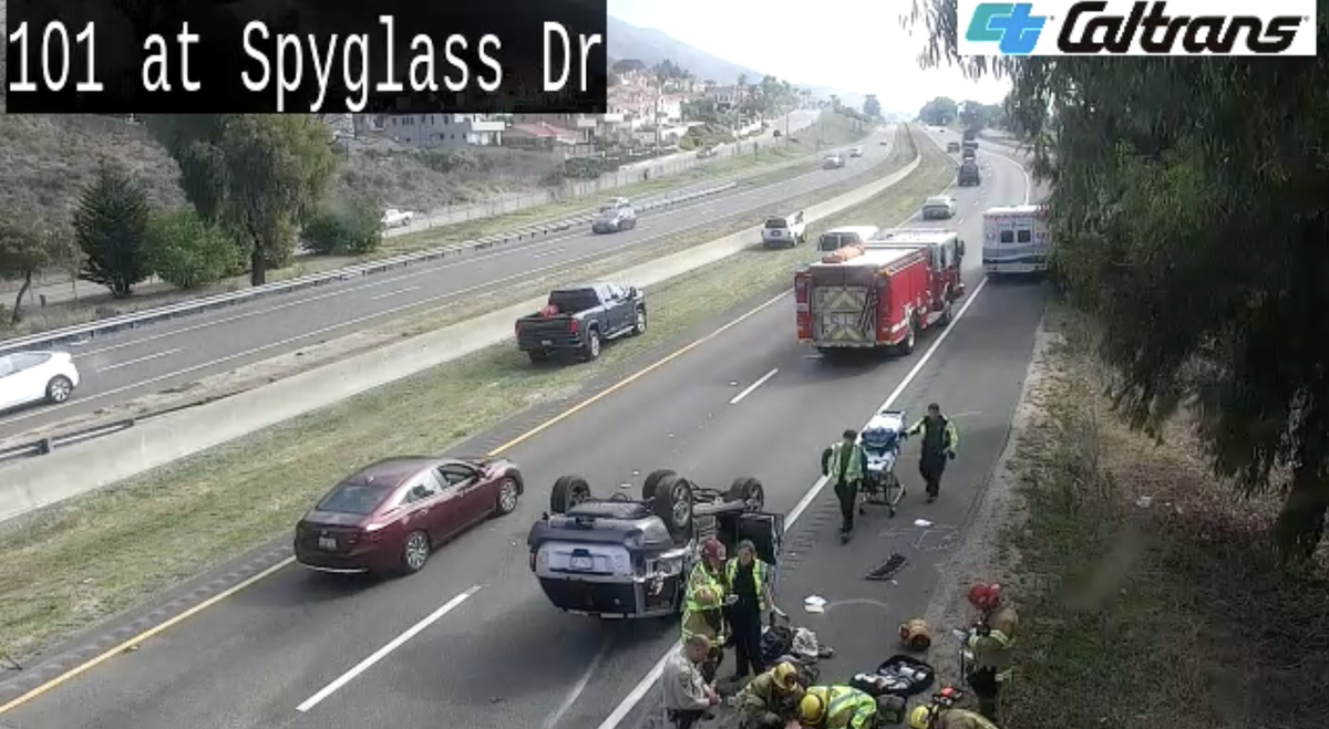 Firefighters and an ambulance respond to a single-vehicle rollover crash that slowed traffic on Highway 101 near the Spyglass exit in Shell Beach on Oct. 31, 2025.