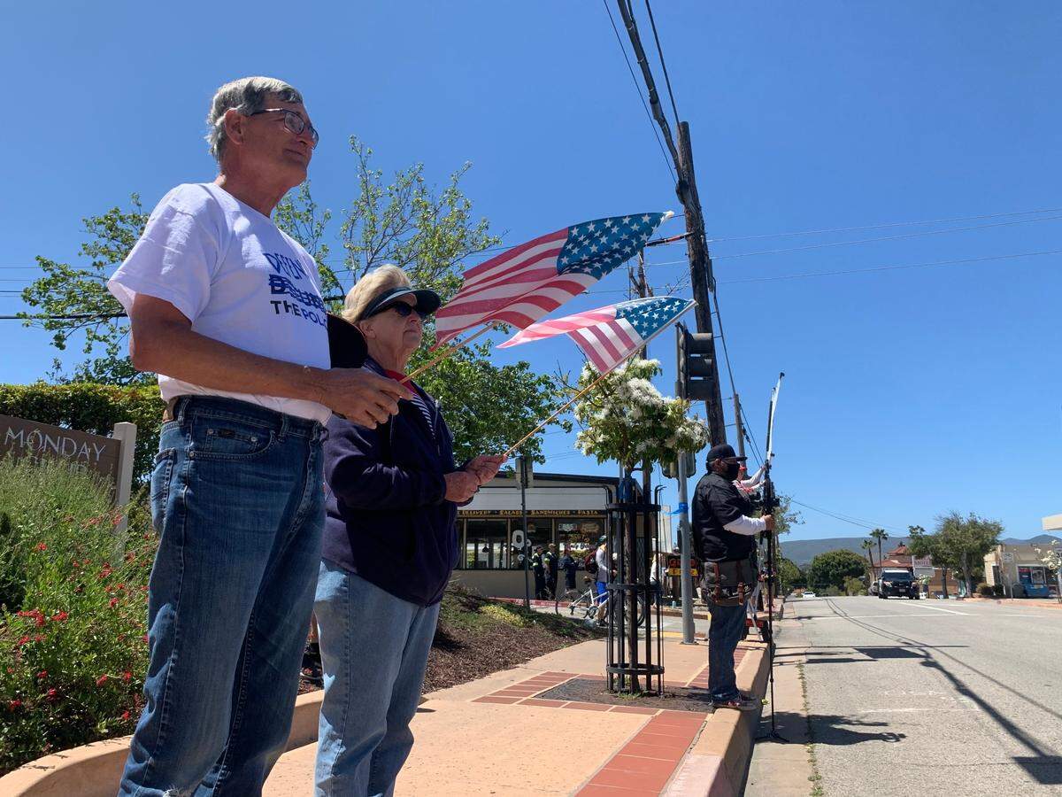 Keith and Cheryl Smith of San Luis Obispo stood on Grand Avenue and Monterey Street outside the Monday Club to pay respect to Det. Luca Benedetti, who was killed May 10.