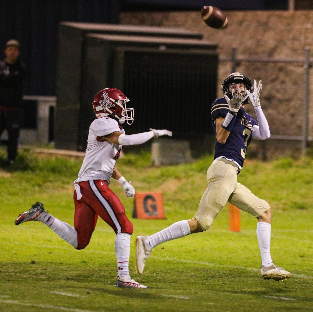 Tyler Garrett catches a pass for a touchdown, pursued by Hayden McKanna. Mission Prep defeated Paso Robles 28-7 in a Mountain League football game on Sept. 30, 2022, in San Luis Obispo.