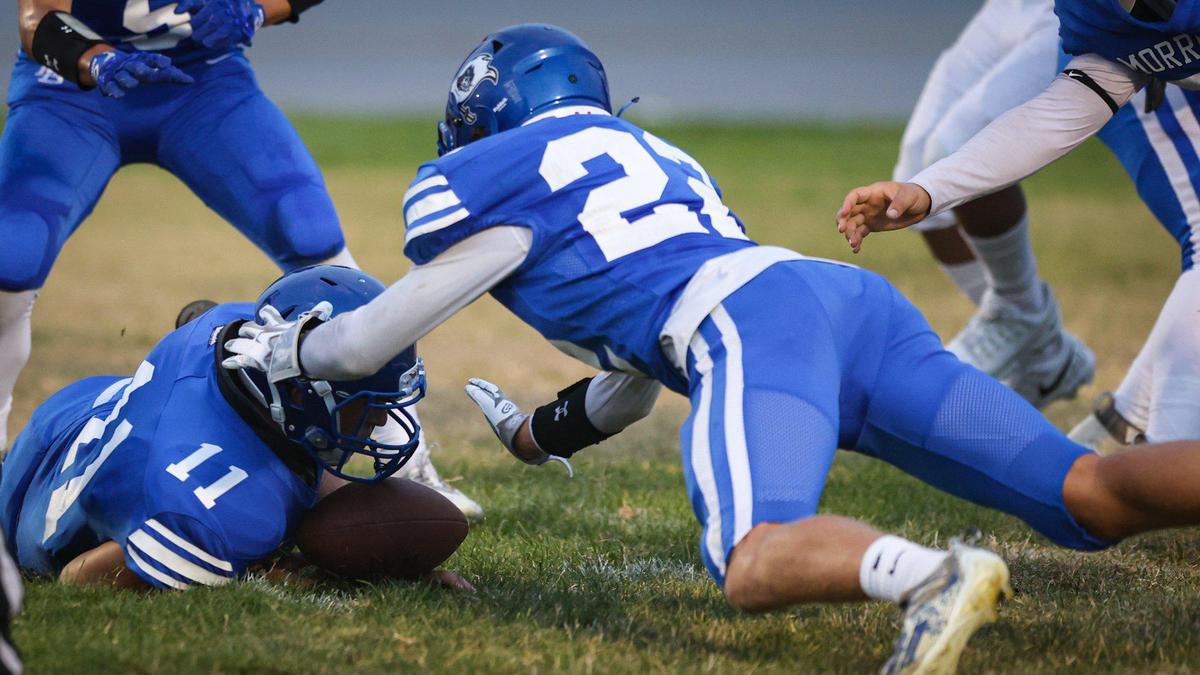 Jackson McMahon gathers up a Fresno fumble for Morro Bay in a game the Pirates led 28-13 over Fresno before it was canceled due to lightning on Sept. 9, 2022.