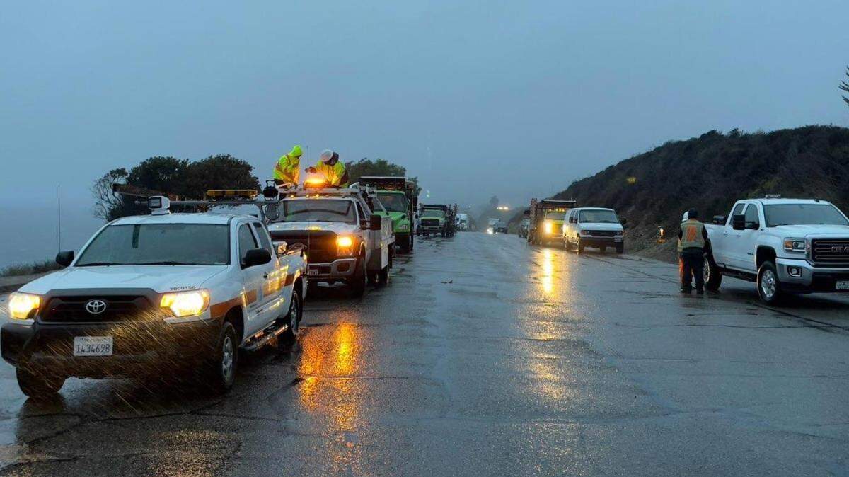 Caltrans crews stage on Highway 101 at the Vista Point on the Gaviota Coast Monday morning as a rain storm passes through the area.