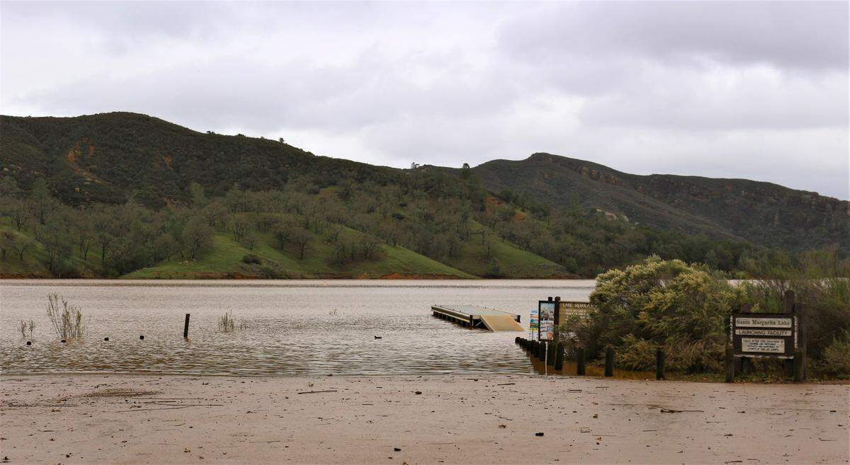 The public boat launch ramp sits underwater and a boat dock floats high on Santa Margarita Lake, which is overflowing after early January rains.