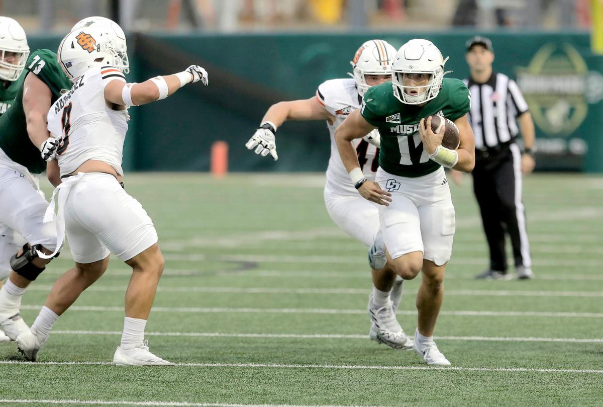 Quarterback Richie Watts runs with the football under pressure by Idaho State’s players. Cal Poly lost to Idaho State 41-38 in a college football game at Mustang Memorial Stadium on Oct. 5, 2024