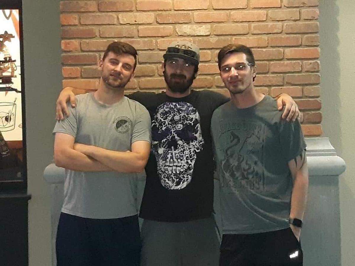 Shooting victim Justin Bice, center, with his brothers, Jeremy Adams, left, and Dylan Bice, 27, right. 