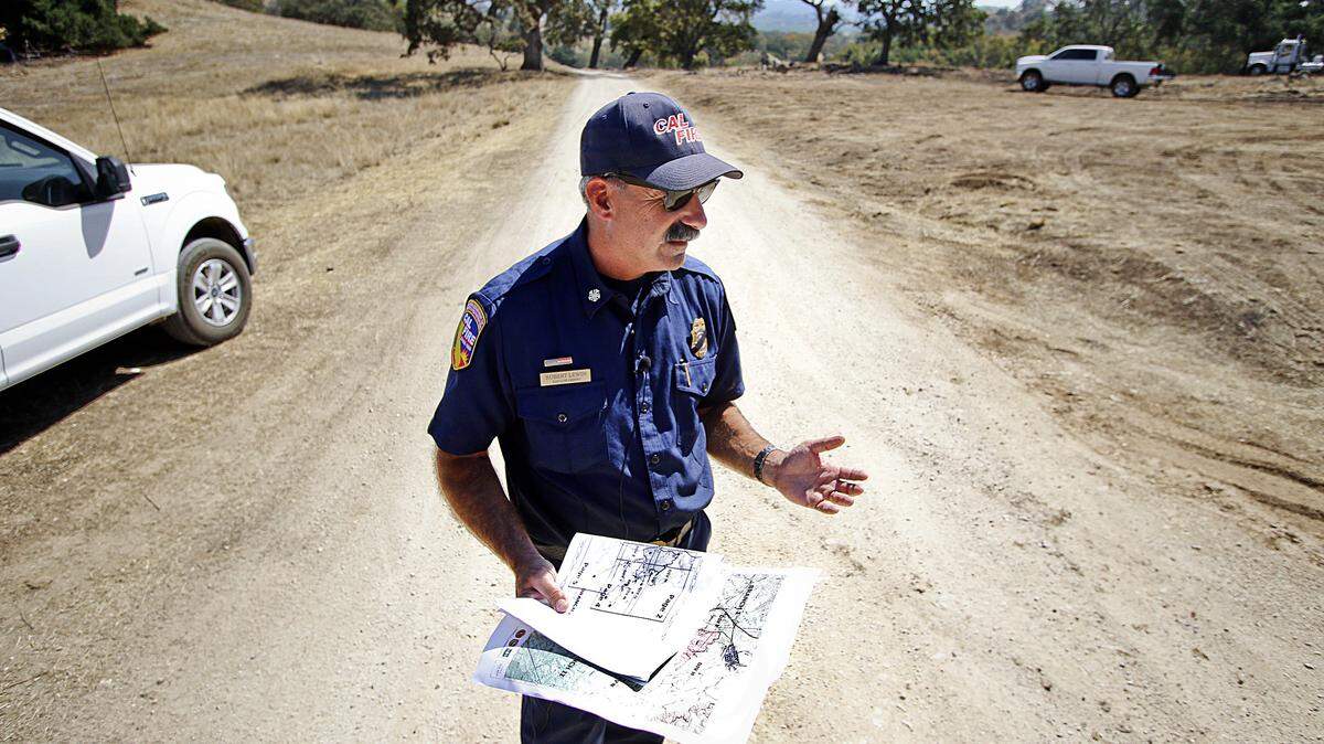 Cal Fire/San Luis Obispo County Fire Chief Robert Lewin recalls the critical points of the Cuesta Fire as he stands on the road where fire crews stopped the fire's advance last week, about a quarter-mile from Santa Margarita.