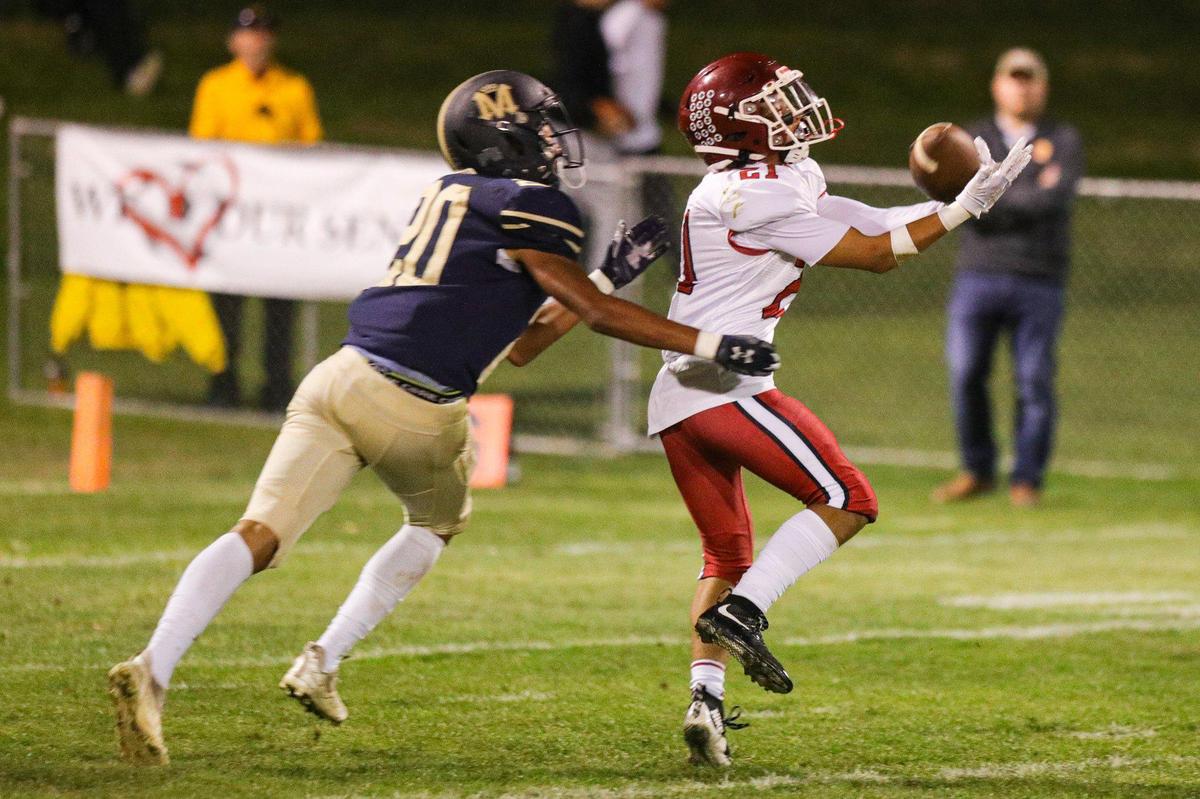Ashton Murphy catches a pass pursued by Jayden Nozil. Mission Prep defeated Paso Robles 28-7 in a football game on Sept. 30, 2022, in San Luis Obispo.