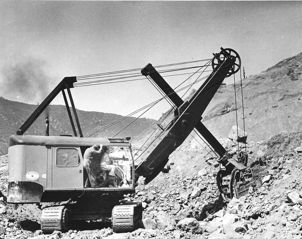 Taking a big bite out of the hill — with Alex Madonna taking a turn at the controls — is this massive power shovel. Cost of rebuilding some sections of twisty Highway 166 sometimes exceeds $1 million a mile. Story published May 22, 1971, on the construction of Highway 166.
