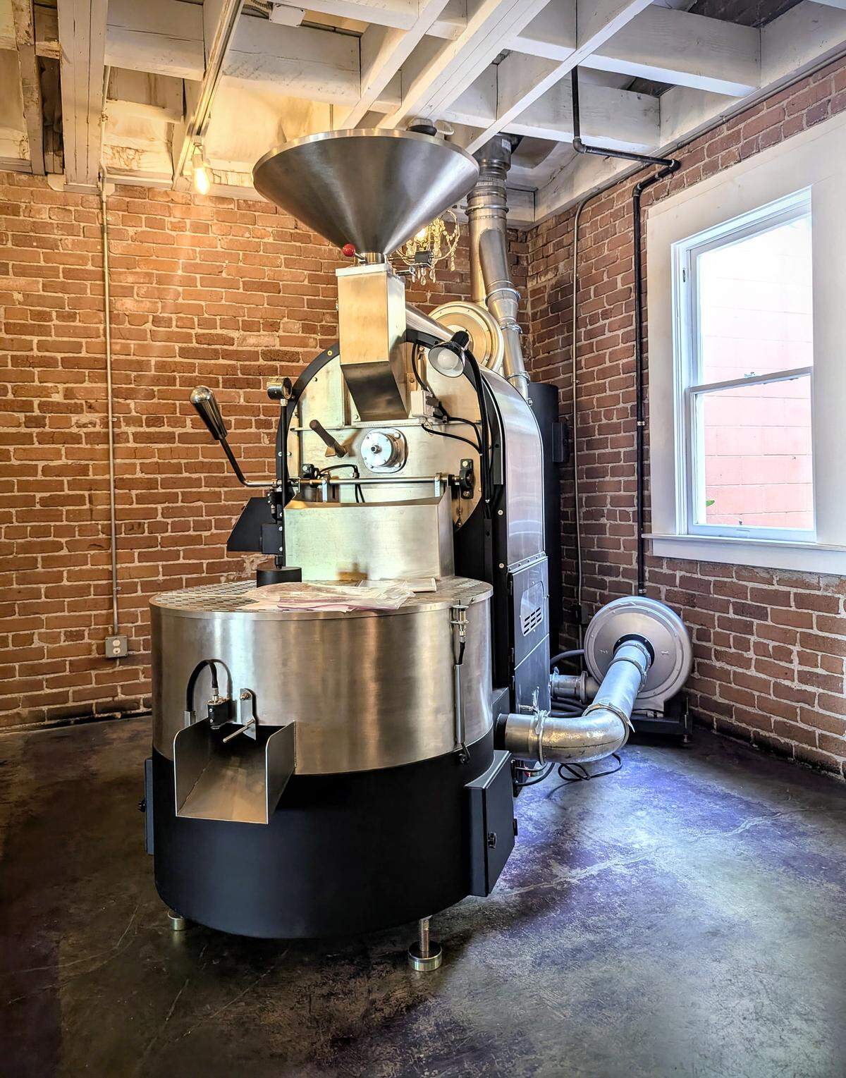 A commercial coffee roaster at AMSTRDM Coffee House in Paso Robles supports roasting operations for the company’s growing network of locations and wholesale accounts.