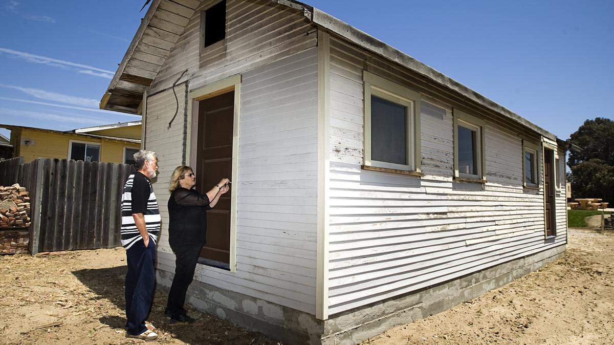 Linda Austin and Norm Hammond of the Oceano Depot Association give a tour of "Gavin's Cabin," once the home of Dunite Gavin Arthur. His cabin is the only one that has survived the Dunite era.